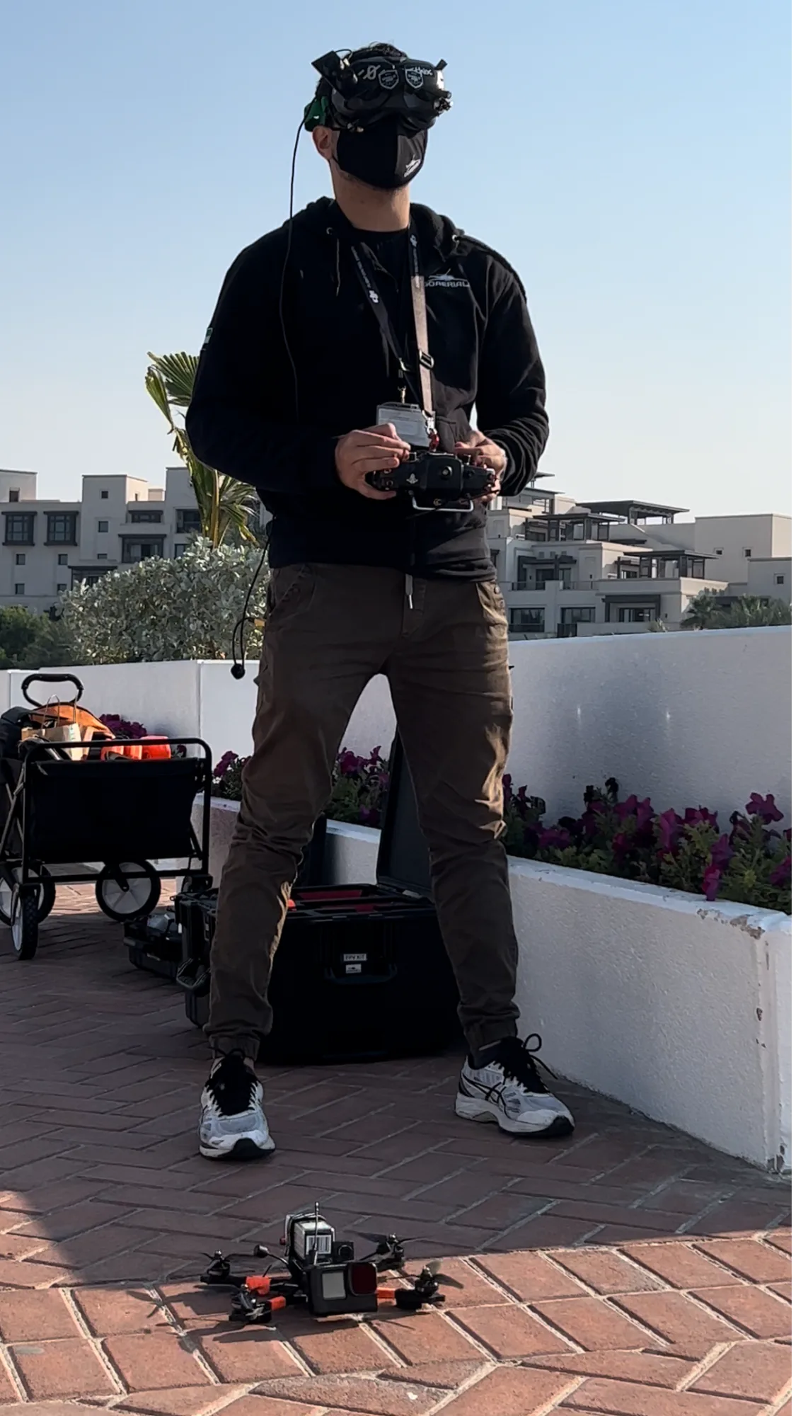 FPV drone pilot in goggles preparing a flight over Dubai